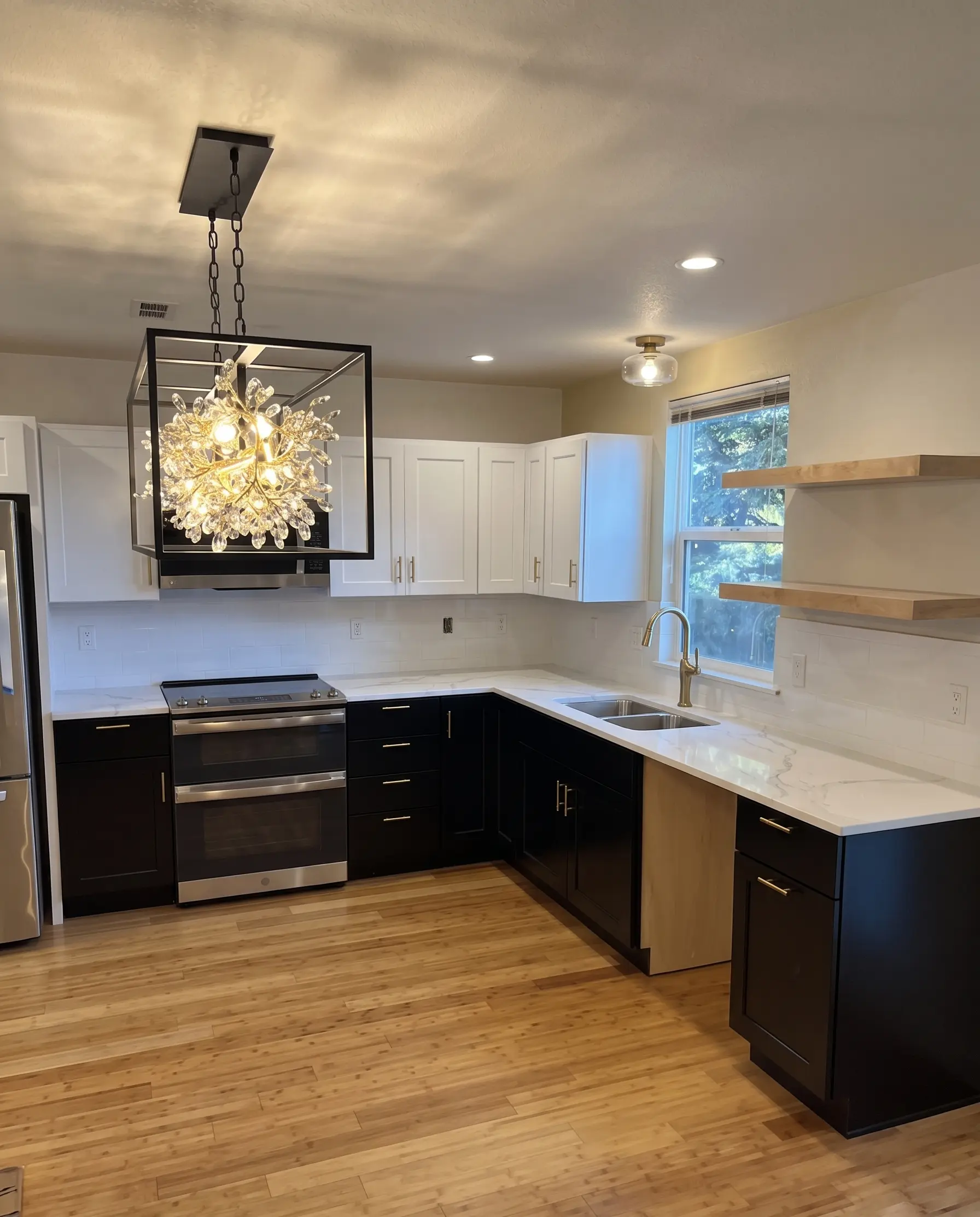 A modern kitchen remodel with custom cabinetry and a statement chandelier