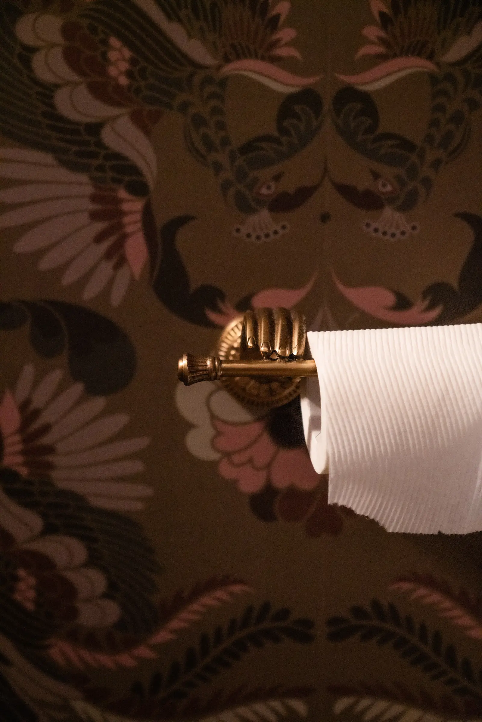 Compact green sink and wallpaper detail in a Boulder powder room